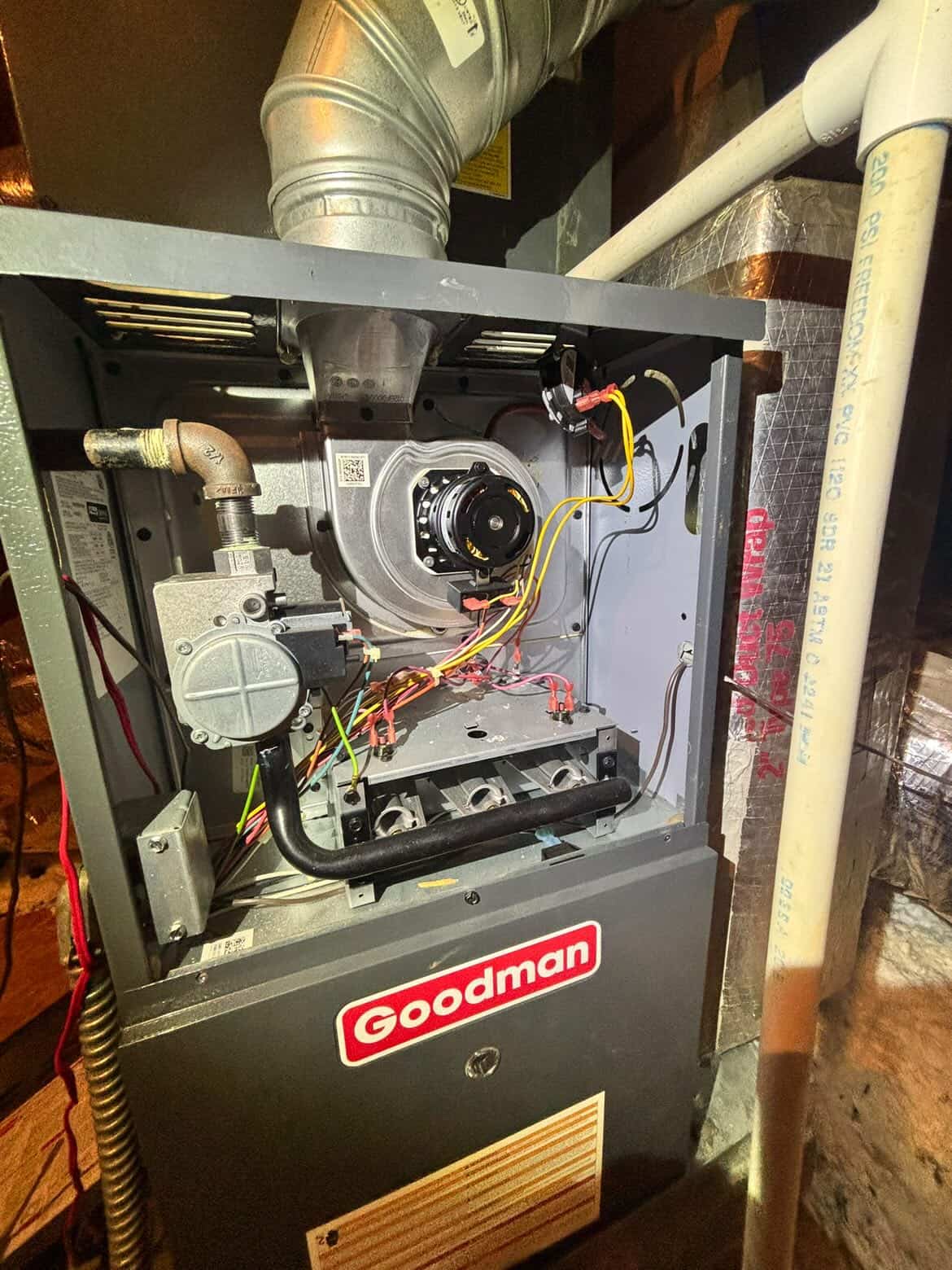 Open Goodman gas furnace mid-service during a heating repair